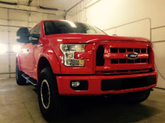 A large red truck with photo taken from the front.
